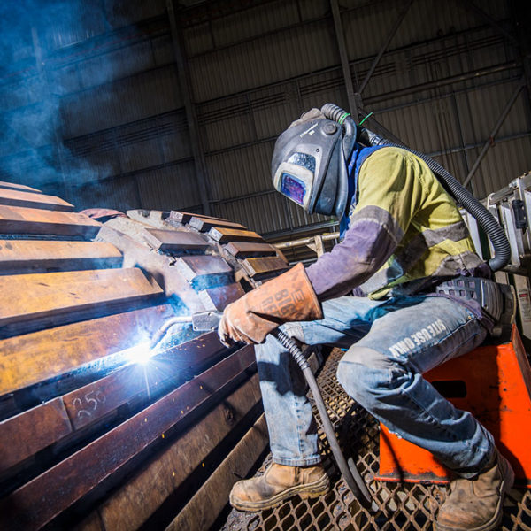 Nathan Brown, Boilermaker welding a loader bucket, Southern Cross Workshop. George Fisher Mine.