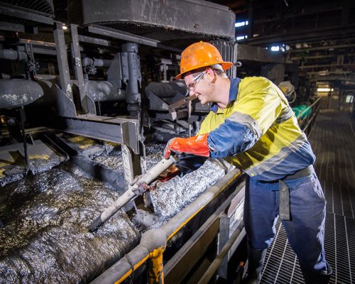 Mitchell Davidson, Processing Metallurgist, Zinc Processing at Glencore's Mount Isa Mines. Mitchell samples pulp during the lead floatation process at the Zinc Lead Concentrator. The photographer is Rob Parsons of Through The Looking Glass Studio. The Image Orientation is Landscape.