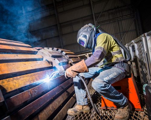 Nathan Brown, Boilermaker welding a loader bucket, Southern Cross Workshop. George Fisher Mine.